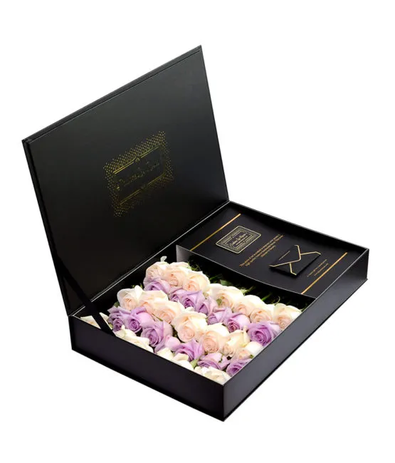purple cream roses in black box